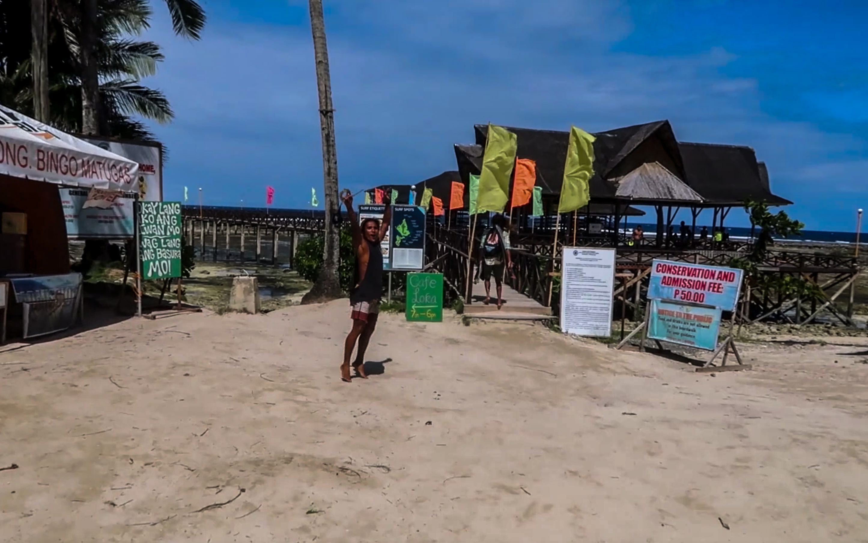 filipino surfer cheering at cloud 9 surfing spot in siargao philippines